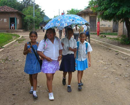 17- Schoolgirls walking home in the Limay heat.